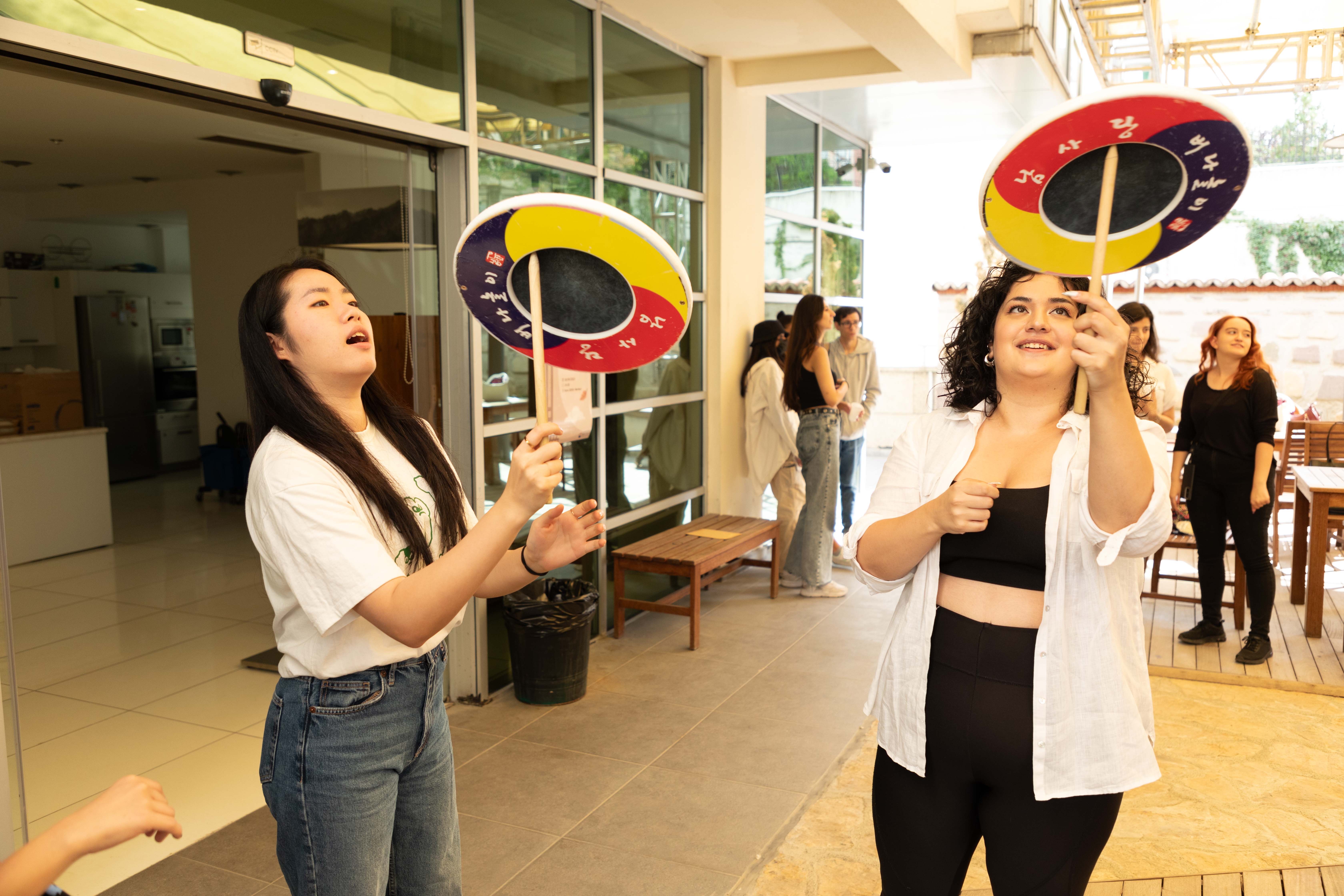 Visitors to the Korean Cultural Center (KCC) in Ankara, Turkiye (Turkey), on Sept. 30, 2023, play beonadolligi, a traditional game using wooden sticks to spin bowls, treadwheels or basins. (KCC in Turkiye)  