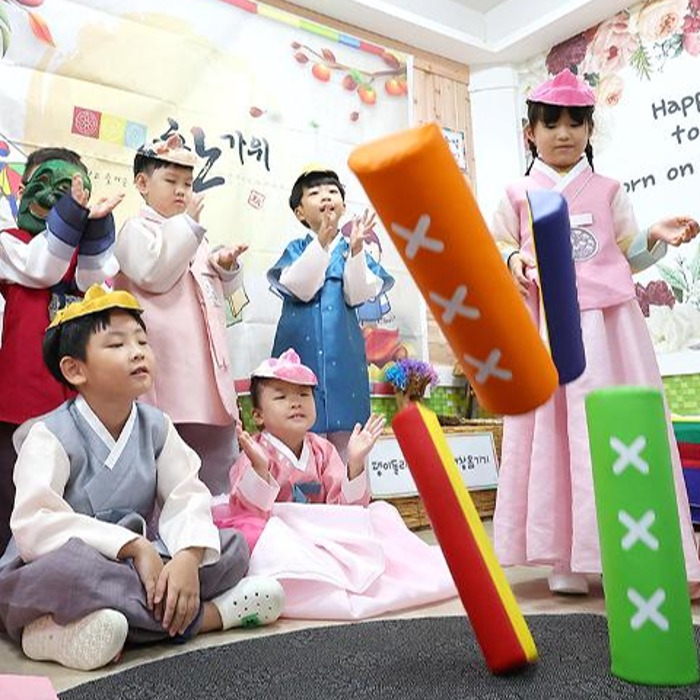 Hanbok-clad children play traditional games